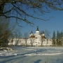 Boczne spojrzenie na klasztor w zimowej otulinie.