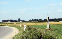 Krzyż przydrożny na zakręcie drogi za wioską